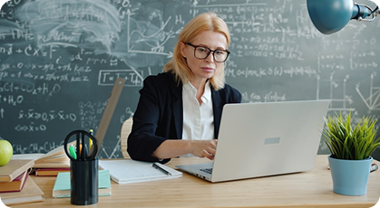 Teacher working at a desk in a classroom