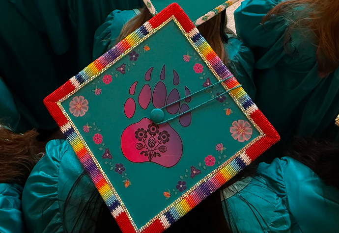 WETCC graduation cap featuring colorful beadwork and floral designs